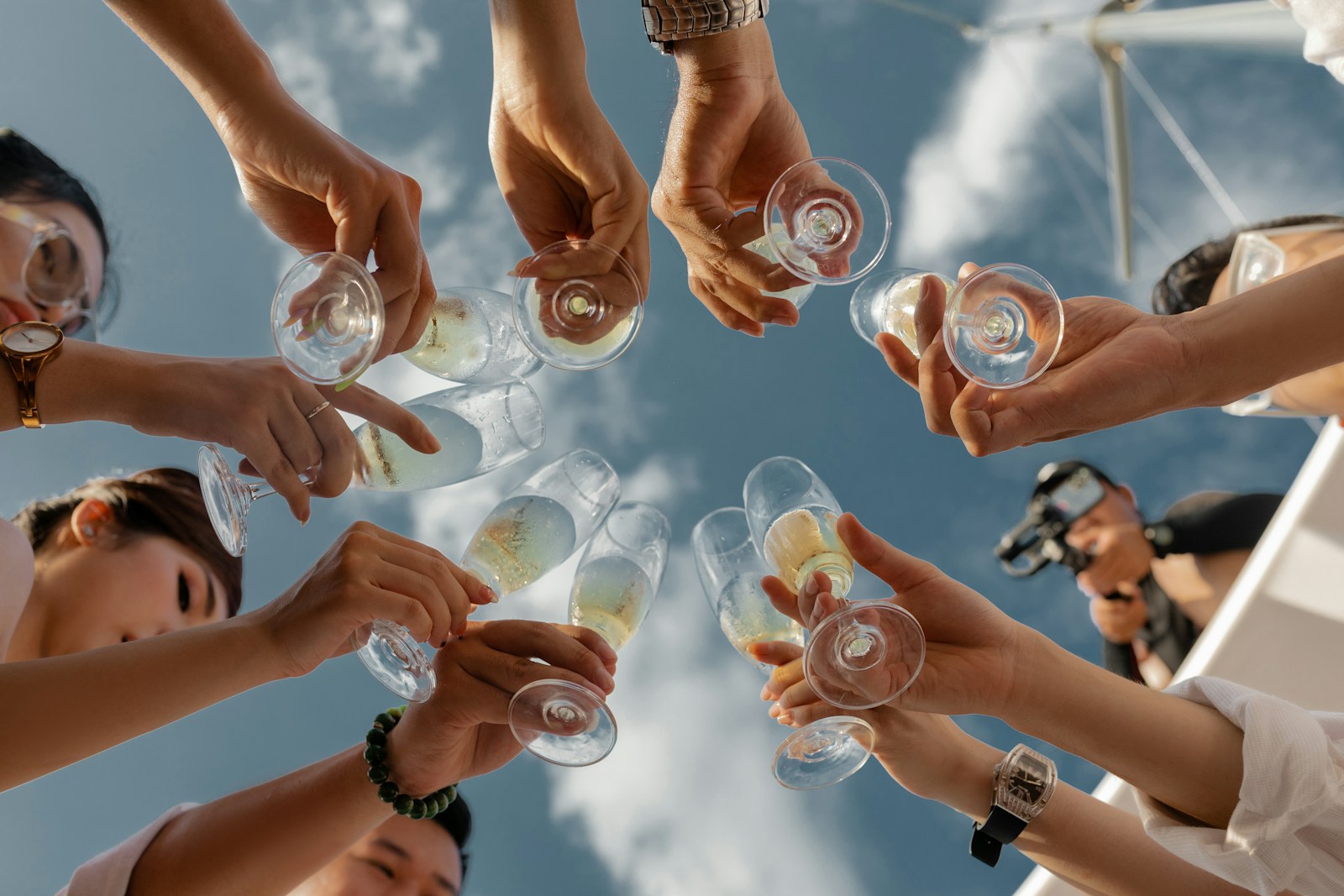 Photo by Quan Nguyen people holding clear glass bottles during daytime