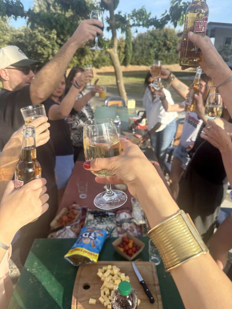 IMG_4974 people holding clear glass bottles during daytime